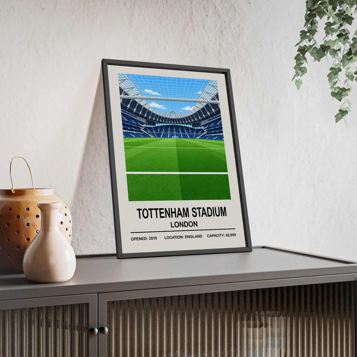 Tottenham Hotspur Tottenham Hotspur Stadium print framed and leaning on a sideboard