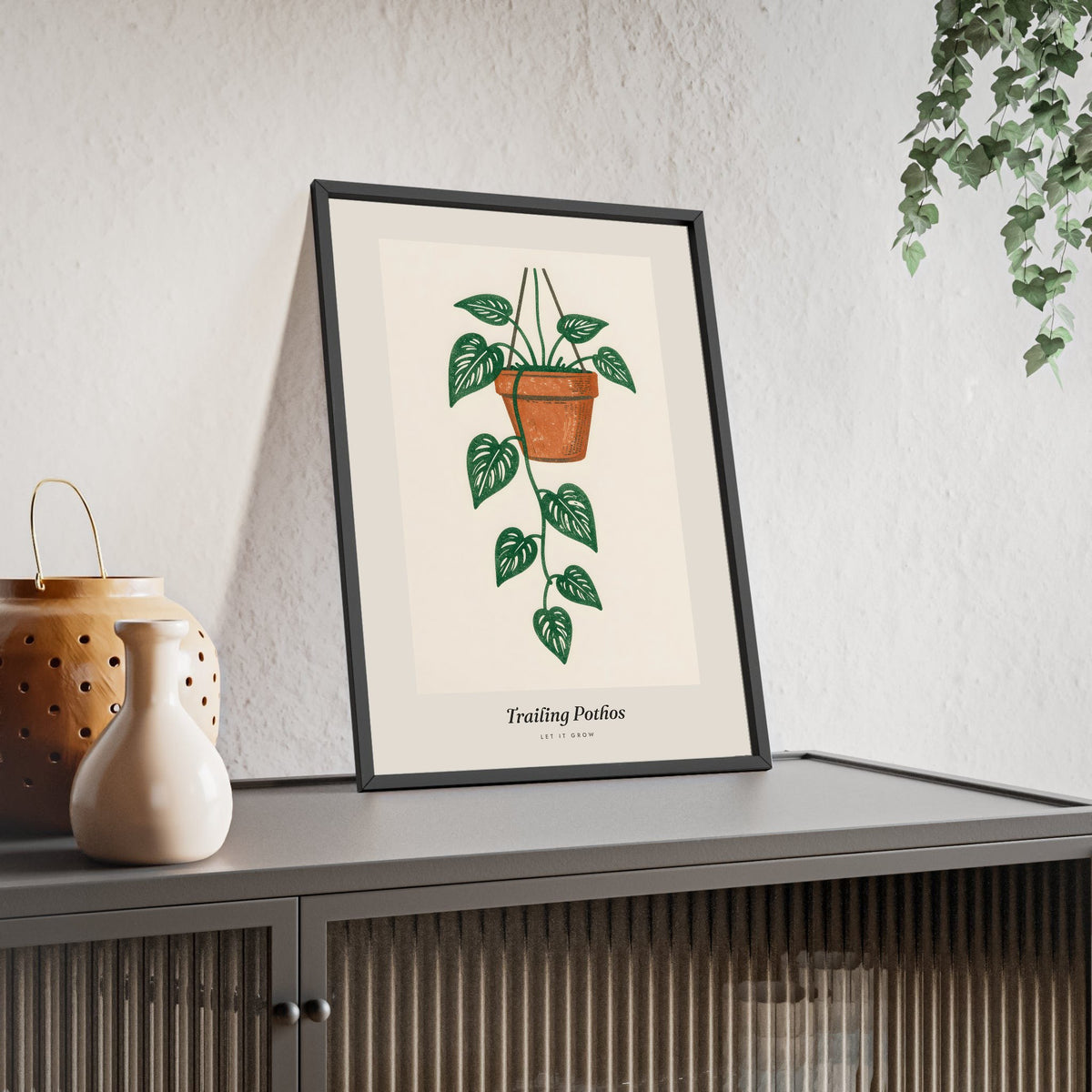 Trailing Pothos Lino Print framed and leaning on a sideboard