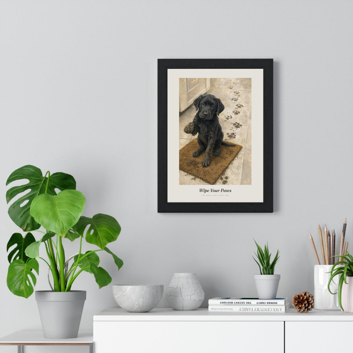 Wipe Your Paws Print framed on a living room wall